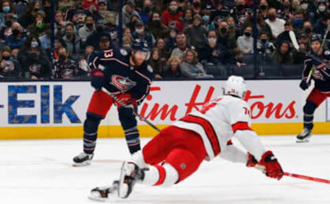 Jan 1, 2022; Columbus, Ohio, USA; Carolina Hurricanes defenseman Jaccob Slavin (74) falls to the ice to block the pass attempt of Columbus Blue Jackets right wing Jakub Voracek (93) during the second period at Nationwide Arena. Mandatory Credit: Russell LaBounty-USA TODAY Sports