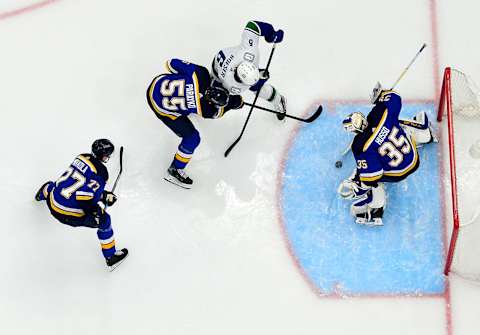 Mar 28, 2022; St. Louis, Missouri, USA; St. Louis Blues goaltender Ville Husso (35) and defenseman Colton Parayko (55) defend the net against Vancouver Canucks right wing Brock Boeser (6) during the second period at Enterprise Center. Mandatory Credit: Jeff Curry-USA TODAY Sports