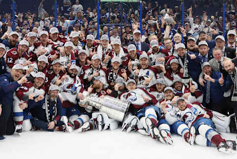 TAMPA, FLORIDA – JUNE 26: The Colorado Avalanche pose with theStanley Cup following the series winning victory over the Tampa Bay Lightning in Game Six of the 2022 NHL Stanley Cup Final at Amalie Arena on June 26, 2022 in Tampa, Florida. (Photo by Bruce Bennett/Getty Images)