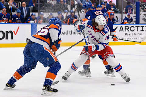 Apr 21, 2022; Elmont, New York, USA; New York Islanders defenseman Sebastian Aho (25) and New York Islanders defenseman Andy Greene (4) defend against New York Rangers left wing Artemi Panarin (10) during the first period at UBS Arena. Mandatory Credit: Dennis Schneidler-USA TODAY Sports