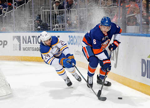 ELMONT, NEW YORK – MARCH 07: Dylan Cozens #24 of the Buffalo Sabres checks Ryan Pulock #6 of the New York Islanders at the UBS Arena on March 07, 2023 in Elmont, New York. (Photo by Bruce Bennett/Getty Images)