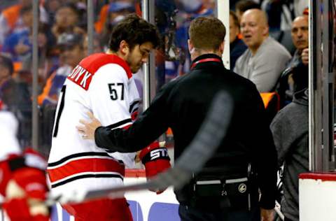 NEW YORK, NEW YORK – APRIL 28: Trevor van Riemsdyk #57 of the Carolina Hurricanes is assisted by the trainer during the first period against the New York Islanders in Game One of the Eastern Conference Second Round during the 2019 NHL Stanley Cup Playoffs at Barclays Center on April 28, 2019 in New York City. (Photo by Mike Stobe/NHLI via Getty Images)