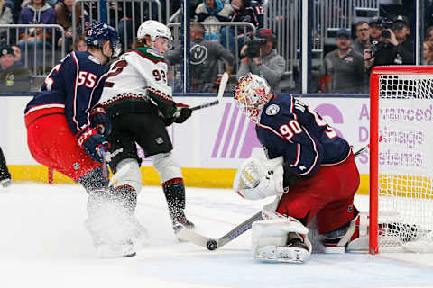 Nov 16, 2023; Columbus, Ohio, USA; Columbus Blue Jackets goalie Elvis Merzlikins (90) stops the tip shot from Arizona Coyotes center Logan Cooley (92) during the third period at Nationwide Arena. Mandatory Credit: Russell LaBounty-USA TODAY Sports