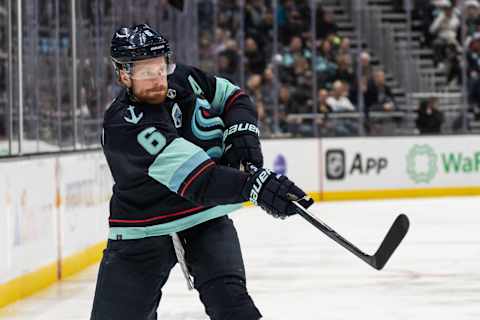 Apr 16, 2022; Seattle, Washington, USA; Seattle Kraken defenseman Adam Larsson (6) takes a shot against the New Jersey Devils at Climate Pledge Arena. Mandatory Credit: Stephen Brashear-USA TODAY Sports