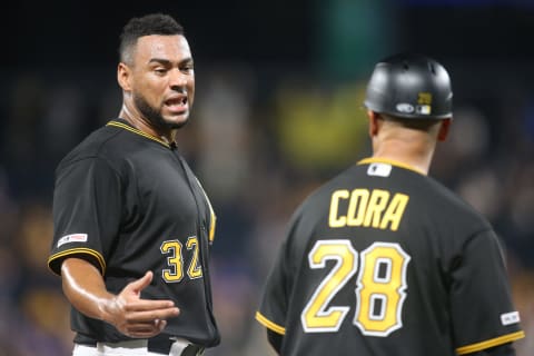 Jul 3, 2019; Pittsburgh, PA, USA; Pittsburgh Pirates catcher Elias Diaz (32) reacts as he talks with third base coach Joey Cora (28) against the Chicago Cubs during the ninth inning at PNC Park. Pittsburgh won 6-5. Mandatory Credit: Charles LeClaire-USA TODAY Sports