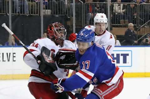 NEW YORK, NEW YORK – NOVEMBER 27: Jesper Fast #17 of the New York Rangers attempts to avoid contact with Petr Mrazek #34 of the Carolina Hurricanes during the second period at Madison Square Garden on November 27, 2019 in New York City. The Rangers defeated the Hurricanes 3-2. (Photo by Bruce Bennett/Getty Images)