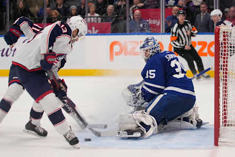 Dec 14, 2023; Toronto, Ontario, CAN; Toronto Maple Leafs goaltender Ilya Samsonov (35) makes a save against Columbus Blue Jackets forward Johnny Gaudreau (13) during overtime at Scotiabank Arena. Mandatory Credit: John E. Sokolowski-USA TODAY Sports