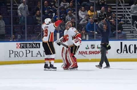 ST. LOUIS, MO – DECEMBER 16: Matthew Tkachuk #19 of the Calgary Flames and David Rittich #33 of the Calgary Flames react after beating the St. Louis Blues 7-2 at Enterprise Center on December 16, 2018 in St. Louis, Missouri. (Photo by Joe Puetz/NHLI via Getty Images)