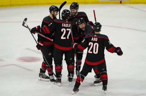 RALEIGH, NC – MAY 01: Carolina Hurricanes right wing Justin Williams (14) celebrates with teammates after scoring the game winning goal during a game between the Carolina Hurricanes and the New York Islanders on May 1, 2019 at the PNC Arena in Raleigh, NC. (Photo by Greg Thompson/Icon Sportswire via Getty Images)