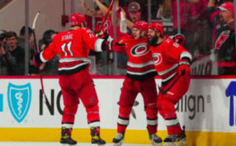 Apr 19, 2023; Raleigh, North Carolina, USA; Carolina Hurricanes right wing Jesper Fast (71) celebrates his game winner with defenseman Brent Burns (8) and center Jordan Staal (11) in the overtime against the New York Islanders in game two of the first round of the 2023 Stanley Cup Playoffs at PNC Arena. Mandatory Credit: James Guillory-USA TODAY Sports                                      The Carolina Hurricanes have punched their ticket to the second round of the Stanley Cup playoffs after an exhilarating 4-2 victory over the New York Islanders in Game 6. These bunch of jerks are on fire!