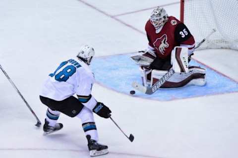 Jan 21, 2016; Glendale, AZ, USA; Arizona Coyotes goalie Louis Domingue (35) makes a save on San Jose Sharks right wing Mike Brown (18) during the second period at Gila River Arena. Mandatory Credit: Matt Kartozian-USA TODAY Sports