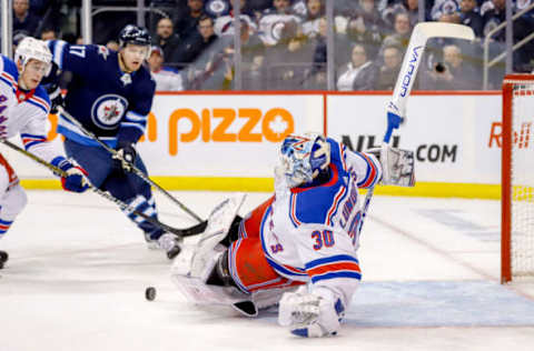 WINNIPEG, MB – FEBRUARY 12: Goaltender Henrik Lundqvist #30 of the New York Rangers makes a sliding pad save during first period action against the Winnipeg Jets at the Bell MTS Place on February 12, 2019 in Winnipeg, Manitoba, Canada. (Photo by Darcy Finley/NHLI via Getty Images)