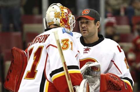 Nov 20, 2016; Detroit, MI, USA; Calgary Flames goalie Brian Elliott (right) shakes hands with goalie Chad Johnson (31) after the game against the Detroit Red Wings at Joe Louis Arena. Flames won 3-2. Mandatory Credit: Raj Mehta-USA TODAY Sports