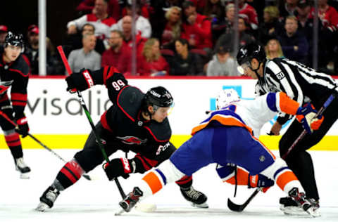 RALEIGH, NC – OCTOBER 11: Erik Haula #56 of the Carolina Hurricanes faces off against Derick Brassard #10 of the New York Islanders during an NHL game on October 11, 2019 at PNC Arena in Raleigh North Carolina. (Photo by Gregg Forwerck/NHLI via Getty Images)