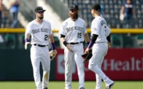 Aug 31, 2016; Denver, CO, USA; Colorado Rockies left fielder Dahl (26) and center fielder Blackmon (19) and right fielder Gonzalez (5) congratulate each other following the game against the Los Angeles Dodgers at Coors Field. The Rockies defeated the Dodgers 7-0. Mandatory Credit: Isaiah J. Downing-USA TODAY Sports