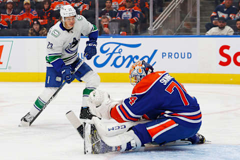 Oct 14, 2023; Edmonton, Alberta, CAN; Vancouver Canucks forward Jack Studnika (23) scores a goal during the second period against Edmonton Oilers goaltender Stuart Skinner (74) at Rogers Place. Mandatory Credit: Perry Nelson-USA TODAY Sports