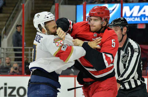 RALEIGH, NC – DECEMBER 02: Carolina Hurricanes Defenceman Noah Hanifin (5) and Florida Panthers Center Derek MacKenzie (17) fight during a game between the Florida Panthers and the Carolina Hurricanes at the PNC Arena in Raleigh, NC on December 2, 2017. Carolina defeated Florida 3-2 in overtime. (Photo by Greg Thompson/Icon Sportswire via Getty Images)