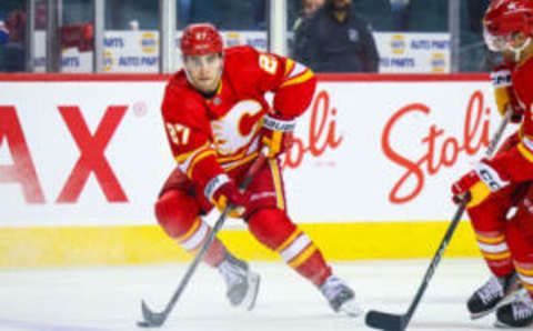 Oct 24, 2023; Calgary, Alberta, CAN; Calgary Flames right wing Matt Coronato (27) controls the puck against the New York Rangers during the second period at Scotiabank Saddledome. Mandatory Credit: Sergei Belski-USA TODAY Sports