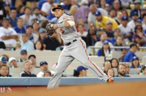 July 5, 2016; Los Angeles, CA, USA; Baltimore Orioles shortstop Manny Machado (13) throws to first after fielding a hit in the sixth inning against Los Angeles Dodgers at Dodger Stadium. Mandatory Credit: Gary A. Vasquez-USA TODAY Sports