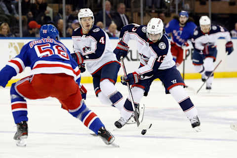 NEW YORK, NEW YORK – NOVEMBER 12: Johnny Gaudreau #13 of the Columbus Blue Jackets controls the puck as Erik Gustafsson #56 of the New York Rangers defends during the first period at Madison Square Garden on November 12, 2023 in New York City. (Photo by Sarah Stier/Getty Images)