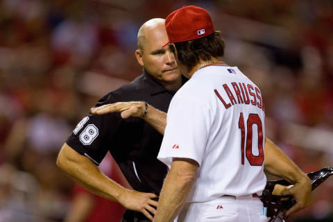 ST. LOUIS – JUNE 28: Home plate umpire Mark Carlson #48 listens to manager Tony LaRussa #10 of the St. Louis Cardinals argue the strike zone against the Arizona Diamondbacks at Busch Stadium on June 28, 2010 in St. Louis, Missouri. The Cardinals beat the Diamondbacks 6-5 in the bottom of the ninth. (Photo by Dilip Vishwanat/Getty Images)