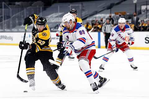 BOSTON, MASSACHUSETTS – MARCH 11: Brad Marchand #63 of the Boston Bruins skates against Pavel Buchnevich #89 of the New York Rangers during the first period at TD Garden on March 11, 2021 in Boston, Massachusetts. (Photo by Maddie Meyer/Getty Images)