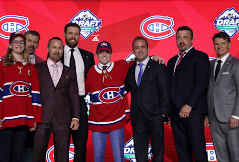 VANCOUVER, BRITISH COLUMBIA – JUNE 21: Cole Caufield (fifth from left), fifteenth overall pick of the Montreal Canadiens, poses for a group photo with team personnel onstage during the first round of the 2019 NHL Draft at Rogers Arena on June 21, 2019 in Vancouver, Canada. (Photo by Dave Sandford/NHLI via Getty Images)