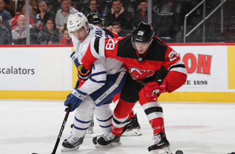 NEWARK, NEW JERSEY – DECEMBER 18: John Tavares #91 of the Toronto Maple Leafs battles for the puck with Damon Severson #28 of the New Jersey Devils during the first period at the Prudential Center on December 18, 2018 in Newark, New Jersey. (Photo by Bruce Bennett/Getty Images)