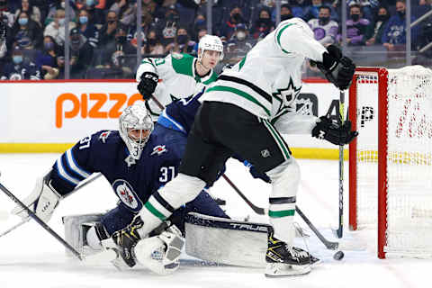 Dallas Stars, Jason Robertson (21); Winnipeg Jets, Connor Hellebuyck (37). Mandatory Credit: James Carey Lauder-USA TODAY Sports