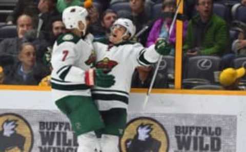 Dec 27, 2016; Nashville, TN, USA; Minnesota Wild right wing Chris Stewart (7) celebrates with defenseman Jared Spurgeon (46) after the game winning goal in overtime against the Nashville Predators at Bridgestone Arena. Minnesota won 3-2 in overtime. Mandatory Credit: Christopher Hanewinckel-USA TODAY Sports