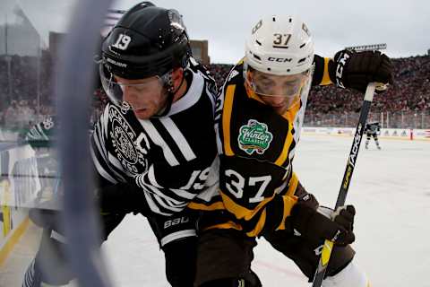 SOUTH BEND, INDIANA – JANUARY 01: Jonathan Toews #19 of the Chicago Blackhawks and Patrice Bergeron #37 of the Boston Bruins battle for the puck in the third period during the 2019 Bridgestone NHL Winter Classic at Notre Dame Stadium on January 01, 2019, in South Bend, Indiana. (Photo by Gregory Shamus/Getty Images)