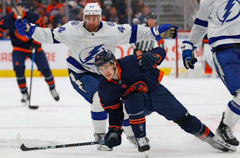 Dec 14, 2023; Edmonton, Alberta, CAN; Tampa Bay Lightning defensemen Calvin de Haan (44) trips up Edmonton Oilers forward Ryan McLeod (71) during the third period at Rogers Place. Mandatory Credit: Perry Nelson-USA TODAY Sports