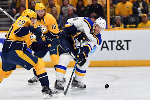 May 2, 2017; Nashville, TN, USA; St. Louis Blues defenseman Carl Gunnarsson (4) takes the puck from Nashville Predators right wing Miikka Salomaki (20) during the first period in game four of the second round of the 2017 Stanley Cup Playoffs at Bridgestone Arena. Mandatory Credit: Christopher Hanewinckel-USA TODAY Sports