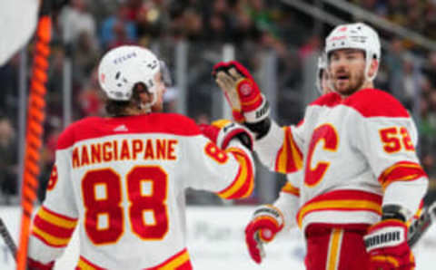 Mar 16, 2023; Las Vegas, Nevada, USA; Calgary Flames defenseman MacKenzie Weegar (52) celebrates with Calgary Flames left wing Andrew Mangiapane (88) after scoring a goal against the Vegas Golden Knights during the first period at T-Mobile Arena. Mandatory Credit: Stephen R. Sylvanie-USA TODAY Sports