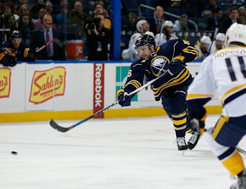 Nov 25, 2015; Buffalo, NY, USA; Buffalo Sabres defenseman Cody Franson (46) takes a shot as Nashville Predators center Cody Hodgson (11) defends during the second period at First Niagara Center. Mandatory Credit: Kevin Hoffman-USA TODAY Sports