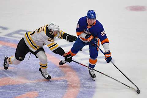 Jan 18, 2021; Uniondale, New York, USA; Boston Bruins defenseman Jeremy Lauzon (55) battles for the puck against New York Islanders center Brock Nelson (29) during the second period at Nassau Veterans Memorial Coliseum. Mandatory Credit: Dennis Schneidler-USA TODAY Sports