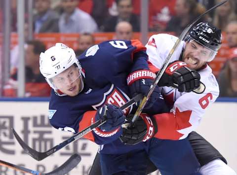 Sep 20, 2016; Toronto, Ontario, Canada; Team USA defenceman Erik Johnson (6) takes a shot as he is checked by Team Canada defenceman Shea Weber (6) during preliminary round play in the 2016 World Cup of Hockey at Air Canada Centre. Canada won 4-2. Mandatory Credit: Dan Hamilton-USA TODAY Sports