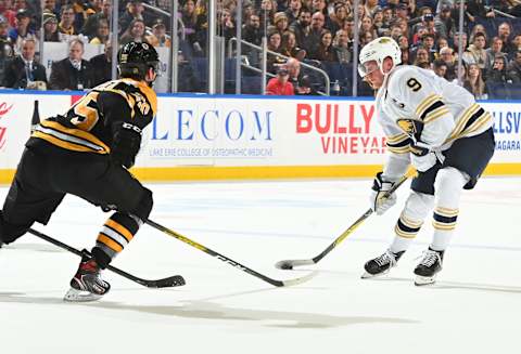 BUFFALO, NY – DECEMBER 27: Jack Eichel #9 of the Buffalo Sabres controls the puck against Brandon Carlo #25 of the Boston Bruins during an NHL game on December 27, 2019 at KeyBank Center in Buffalo, New York. Boston won 3-0. (Photo by Joe Hrycych/NHLI via Getty Images)