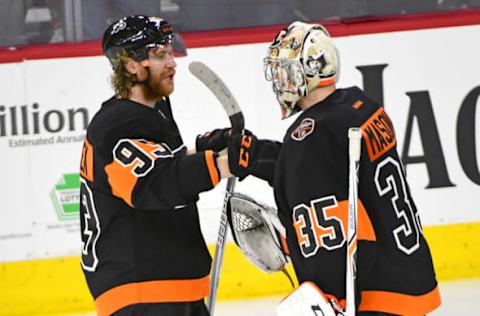 Mar 15, 2017; Philadelphia, PA, USA; Philadelphia Flyers right wing Jakub Voracek (93) and goalie Steve Mason (35) celebrate a win against the Pittsburgh Penguins at Wells Fargo Center. The Flyers defeated the Penguins, 4-0. Mandatory Credit: Eric Hartline-USA TODAY Sports