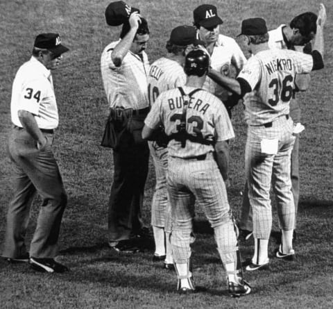 Twins’ veteran Pitcher Joe Niekro is asked by umpires to empty his pockets during 4th inning action. Niekro was then ejected from the game for defacing the ball when an emery board was found on his person. Umpires from left are Dan Morrison-3B. Tim Taeida HP, David Phillips 1B, Alan Clark 2B. Twins manager Tom Kelly is standing in front of Twins catcher Sal Butera.