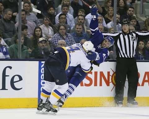 Jan 2, 2016; Toronto, Ontario, CAN; St. Louis Blues defenceman Carl Gunnarsson (4) takes down Toronto Maple Leafs forward Nazem Kadri (43) during the second period at the Air Canada Centre. Mandatory Credit: John E. Sokolowski-USA TODAY Sports