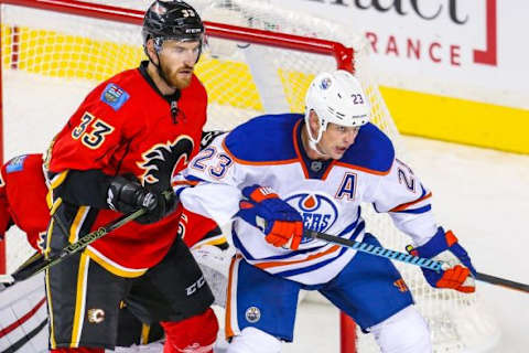 Sep 21, 2015; Calgary, Alberta, CAN; Edmonton Oilers center Matt Hendricks (23) and Calgary Flames defenseman Jakub Nakladal (33) fight for position during the third period at Scotiabank Saddledome. Edmonton Oilers won 3-1. Mandatory Credit: Sergei Belski-USA TODAY Sports