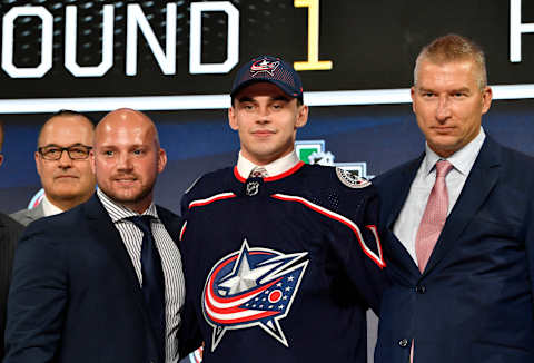 Jun 22, 2018; Dallas, TX, USA; Liam Foudy poses for a photo with team representatives after being selected as the number eighteen overall pick to the Columbus Blue Jackets in the first round of the 2018 NHL Draft at American Airlines Center. Mandatory Credit: Jerome Miron-USA TODAY Sports