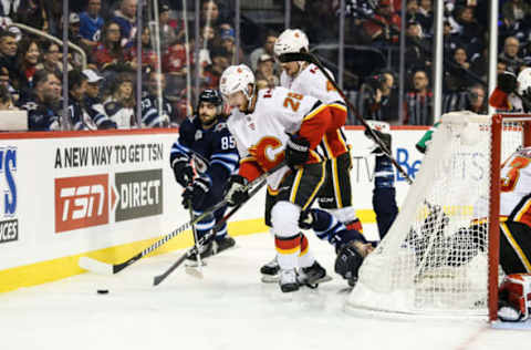 WINNIPEG, MB December 27: Calgary Flames defenseman Michael Stone (26) skates away from Winnipeg Jets forward Matthieu Perreault (85) during the regular season game between the Winnipeg Jets and the Calgary Flames on December 27, 2018 at the Bell MTS Place in Winnipeg MB. (Photo by Terrence Lee/Icon Sportswire via Getty Images)