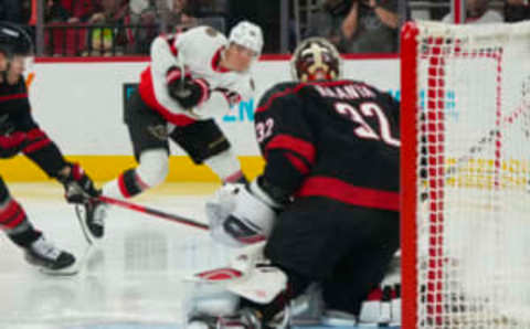 Feb 24, 2023; Raleigh, North Carolina, USA; Ottawa Senators left wing Tim Stützle (18) takes a shot on Carolina Hurricanes goaltender Antti Raanta (32) during the second period at PNC Arena. Mandatory Credit: James Guillory-USA TODAY Sports