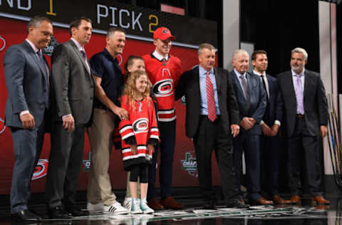 DALLAS, TX – JUNE 22: Andrei Svechnikov poses for a photo onstage after being selected second overall by the Carolina Hurricanes while general manager Don Waddell looks on during the first round of the 2018 NHL Draft at American Airlines Center on June 22, 2018 in Dallas, Texas. (Photo by Brian Babineau/NHLI via Getty Images)