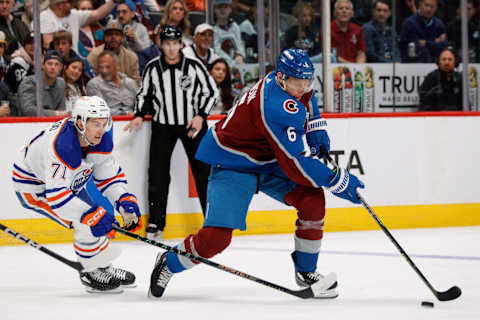 Apr 11, 2023; Denver, Colorado, USA; Colorado Avalanche defenseman Erik Johnson (6) controls the puck ahead of Edmonton Oilers center Ryan McLeod (71) in the second period at Ball Arena. Mandatory Credit: Isaiah J. Downing-USA TODAY Sports