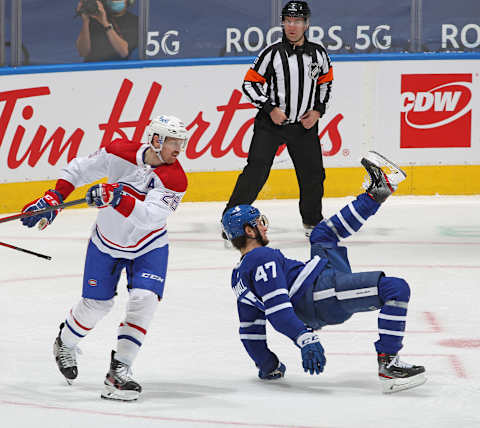 TORONTO, ON – MAY 6: Referee Kendrick Nicholson #30 keeps a close eye on a hit by Jeff Petry #26 of the Montreal Canadiens against Pierre Engvall #47 of the Toronto Maple Leafs (Photo by Claus Andersen/Getty Images)