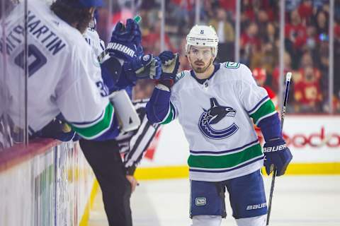 Apr 23, 2022; Calgary, Alberta, CAN; Vancouver Canucks right wing Conor Garland (8) celebrates his goal with teammates against the Calgary Flames during the third period at Scotiabank Saddledome. Mandatory Credit: Sergei Belski-USA TODAY Sports