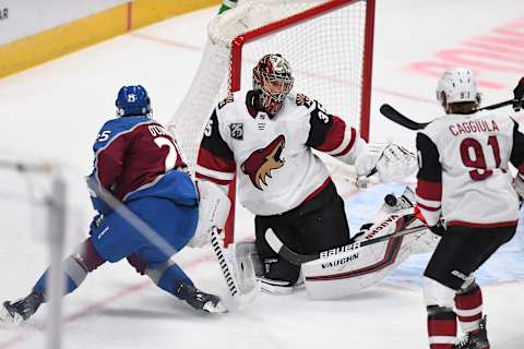 Mar 8, 2021; Denver, Colorado, USA; Arizona Coyotes goaltender Darcy Kuemper (35) makes a pad save on right wing Logan O’Connor (25) in the first period at Ball Arena. Mandatory Credit: Ron Chenoy-USA TODAY Sports